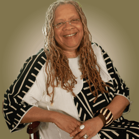 Gretta Chamberlain Profile Image - sitting in chair in a black and white outfit. Gretta Chamberlain Profile Image - sitting in chair in a black and white outfit.